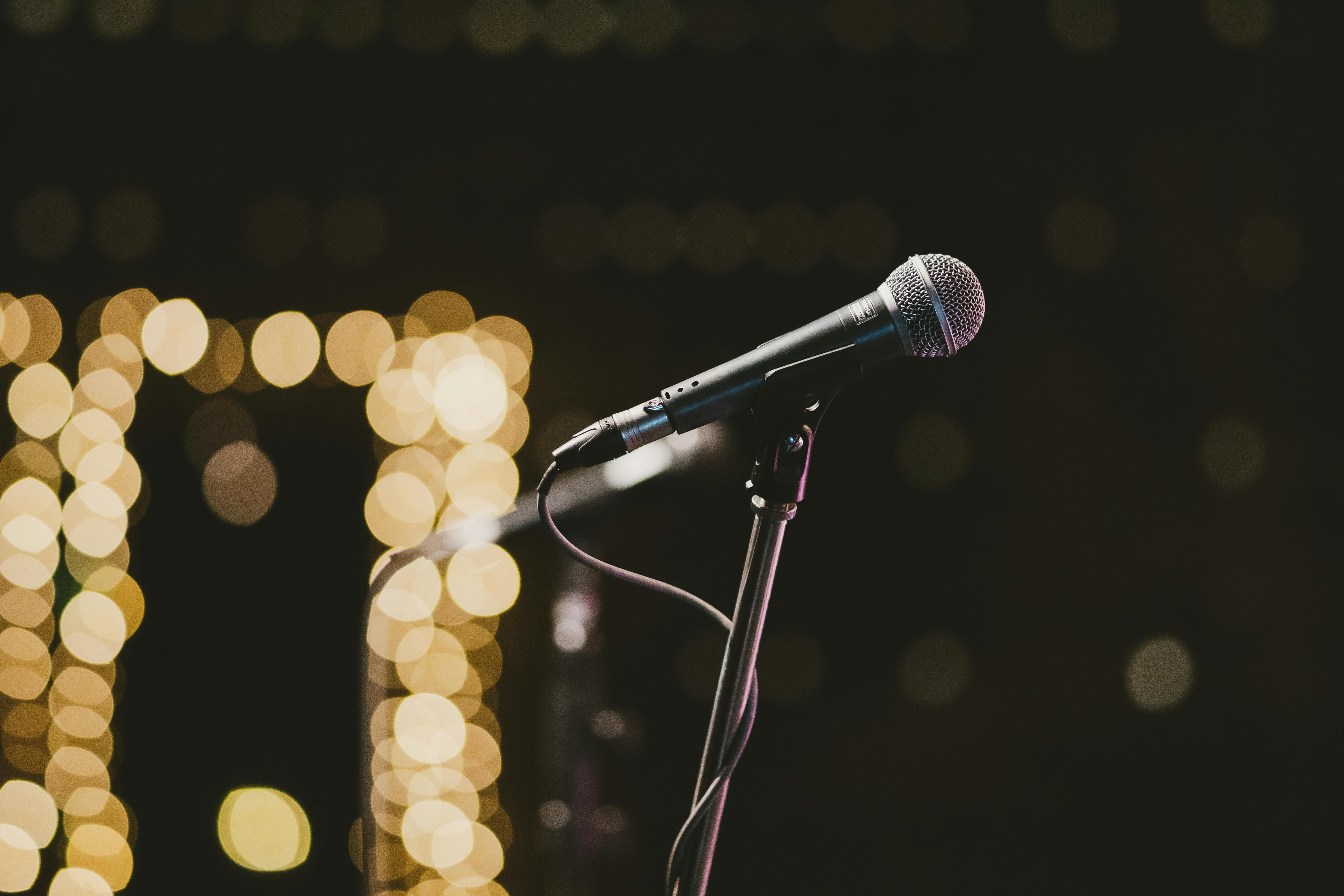 A person doing stand up comedy with a microphone